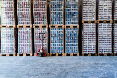 High-bay warehouse with canned goods stacked on pallets