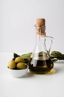 Close up bottle organic olive oil olives
