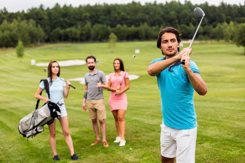 Friends playing golf field