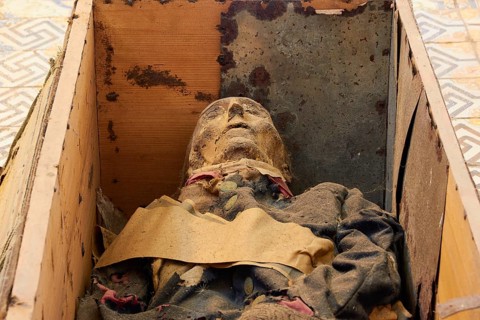 Coffin with mummy lying on the floor