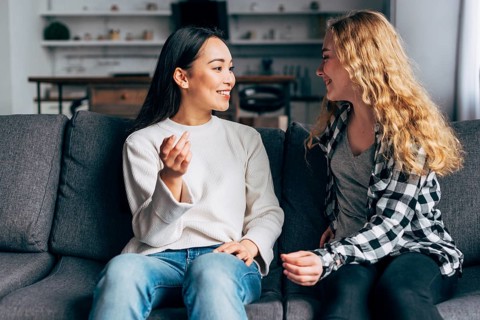 Friends communicate sitting couch