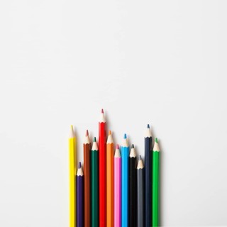 Row sharp colored pencils against white background