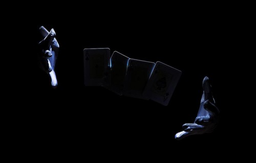 Magician s hand performing trick with playing card