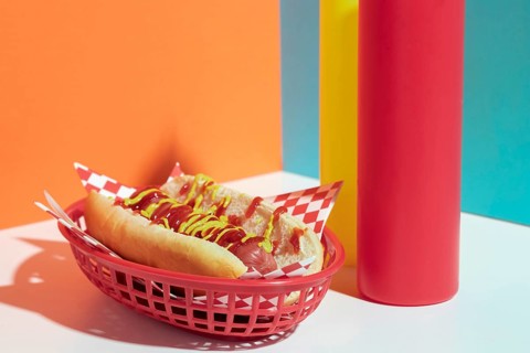 Arrangement with hot dog basket sauce bottles
