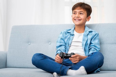 Low angle boy playing with joystick