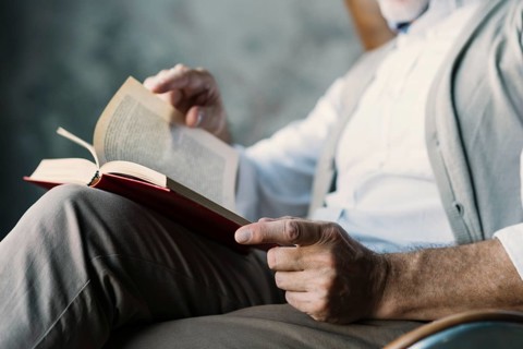 Close up man turning pages book