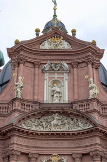 The historic facade with sculptures Neumuenster Catholic Church also Neumuenster St John the Evangelist and St John the Baptist