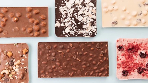 Top view chocolate bars with nuts berries