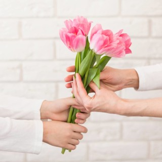 Boy offering flowers mother