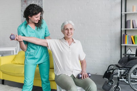 Physiotherapist working elderly patient modern clinic