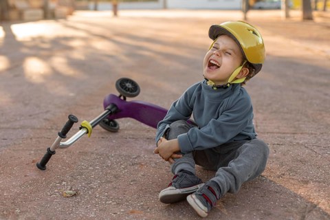 Little boy outdoors hurt from feel scooter