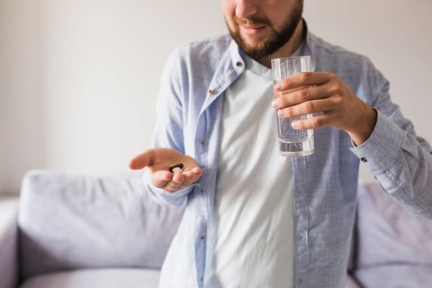 Male grey will pills glass water