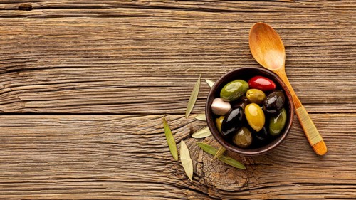 Olives mix wooden spoon with copy space