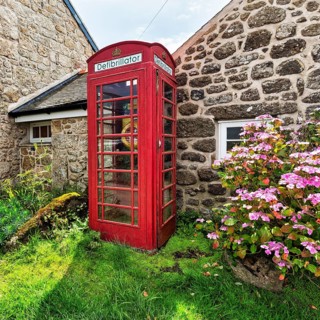Red telephone box with defibrillator inscription