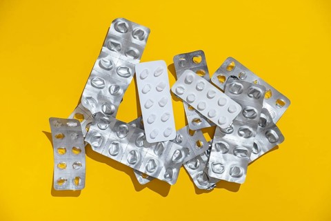 Empty tablet blister pack against a monochrome background