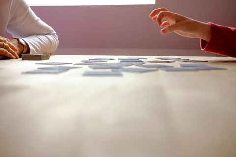 A child plays memory with his grandma