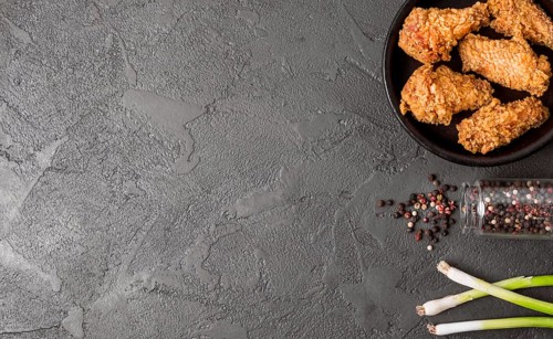 Top view fried chicken with pepper copy space