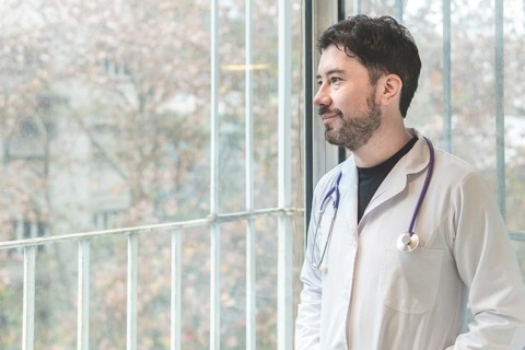 Portrait of latin doctor posing in his office
