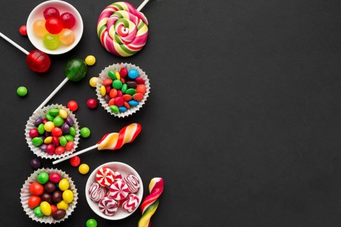 Top view tasty candies black table