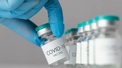 Doctor holding covid 19 vaccine bottle