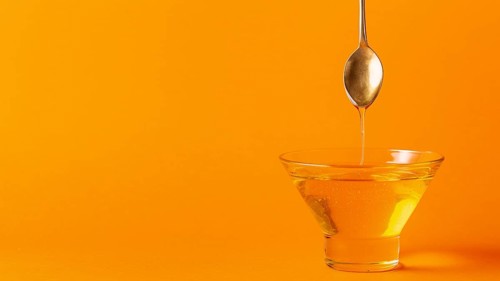 Honey dripping off spoon bowl