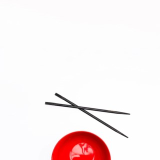 Empty red bowl chopstick isolated white background