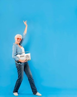 Modern senior woman with vintage radio