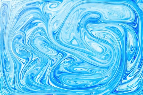 Style ebru painting with blue acrylic paint swirls