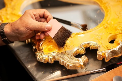 Detail of a mirror gilded with gold leaf