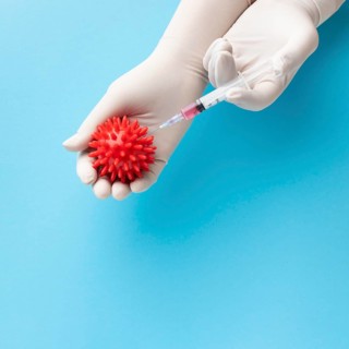 Top view hand holding virus syringe with vaccine