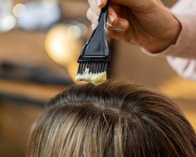 Woman getting her hair dyed home by hairdresser