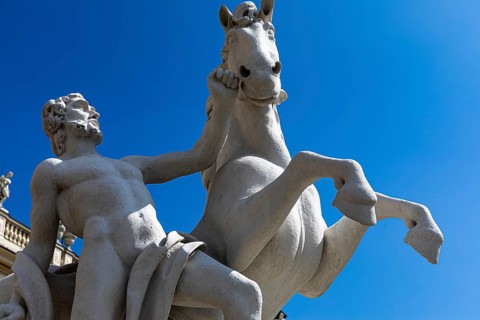 Stone horse and rider figure in front of the Belvedere Upper Baroque Palace