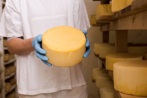 Man holding cheese roll
