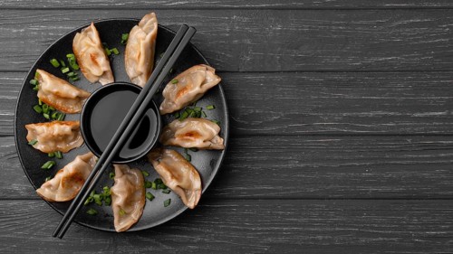 Traditional dumplings plate with chopsticks