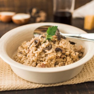 Delicious mushroom risotto white bowl with spoon