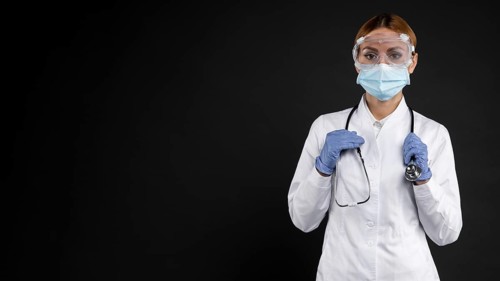 Female doctor wearing protective medical equipment