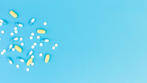 Top view medical pills capsules blue background