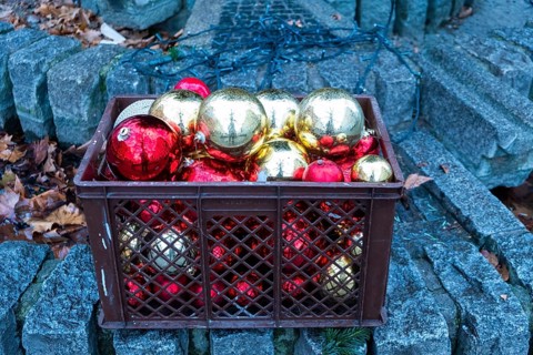 Red and golden Christmas tree balls in a plastic basket