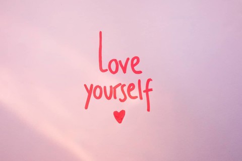 Love yourself inscription purple table