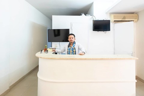 Latino doctor in the reception area of his clinic