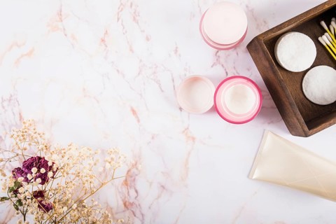 Overhead view moisturizing cream flowers marble