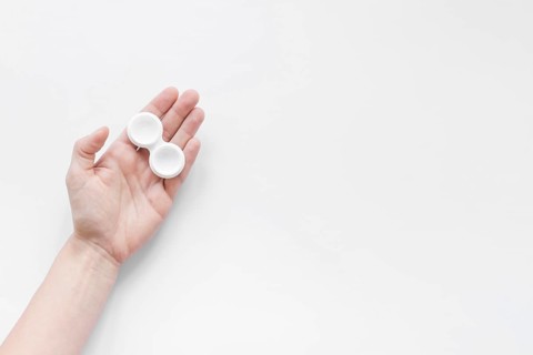 Container lenses hand white background