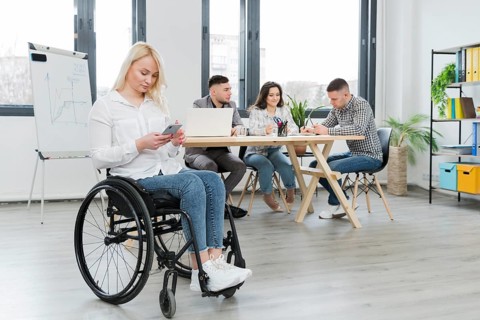 Woman wheelchair working from her phone office