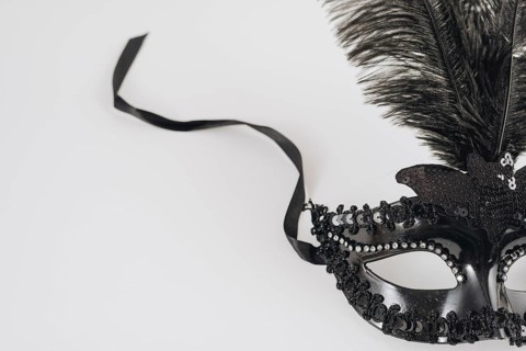 Black carnival mask with feather table