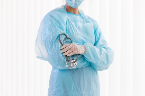 Front view female doctor wearing protective clothing