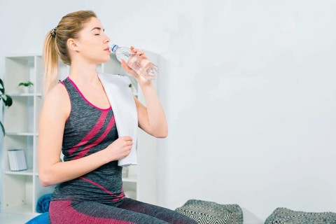 Fitness young woman sportswear drinking water from bottle