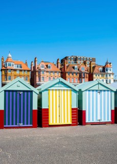 Row of beautiful colourful seaside bathing cottages in Brighton and Hove