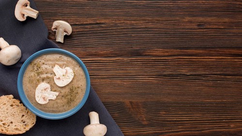 Top view winter mushroom soup bowl with copy space