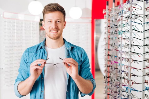Man looking new glasses optometrist