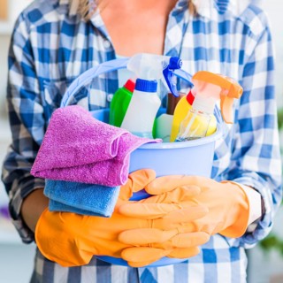 Mid section woman holding cleaning equipments blue bucket
